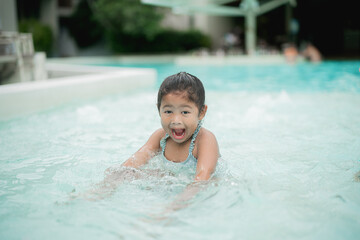 Girl playing in the pool