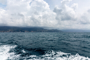 View to the shore near Portofino from the sea with dramatic sky