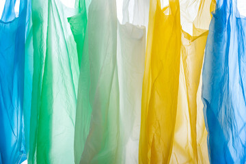 background of colorful disposable plastic bags, vertical structure, close up, plastic waste...