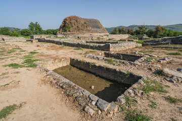 Scenic landscape view of the buddhist ruins of historic Dharmarajika, the Great Stupa in ancient Taxila, Punjab, Pakistan, UNESCO World Heritage site
