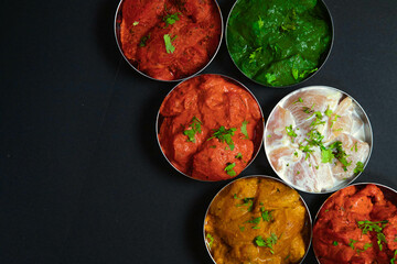 multicolor cuisine, multicolored chicken or mutton with many flavors, white chicken, red meat, green beef, yellow meats, non-vegetarian on the steel bowl in black background