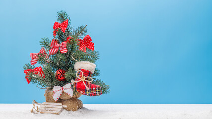 Cozy winter charm: Small decorated snowy Christmas tree