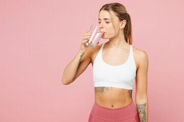 Young Caucasian woman she wearing white top casual clothes hold in hand glass drink water isolated...