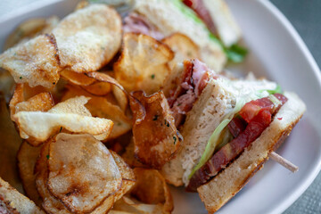 Close up view of club sandwich and house made chips