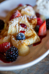 Close up on a french crepe with sugar and berries