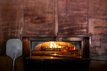 Wood fired brick oven with pizzas cooking