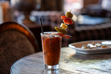 A bloody Mary drink with a tall over the top garnish
