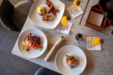 Colorful variety of breakfast foods on table from above