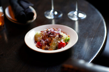 A loaded salad in a bowl on dark table