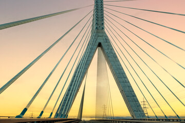 Fototapeta premium Stunning View of Modern Cable-Stayed Bridge at Sunset With Vibrant Colors Illuminating Sky