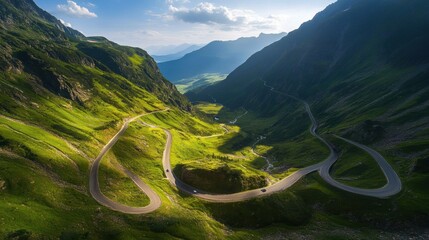 A breathtaking view of winding roads through lush green mountains, illuminated by sunlight, showcasing nature's serene beauty.