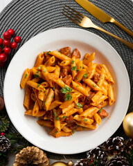 Italian macaroni with chorizo ​​and tomato sauce. Top view table with Christmas decorations.