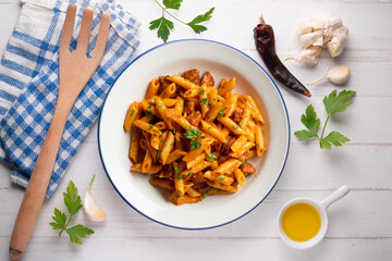 Italian macaroni with chorizo ​​and tomato sauce. Top view table with  decorations.