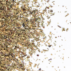Dry basil spice seasoning macro texture on white background.