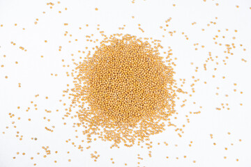 Mustard seeds on white background, natural organic seasoning, top view.