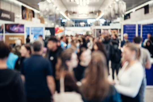 Abstract blurred people at exhibition hall of expo event trade show. Business convention show or job fair. Business concept background.