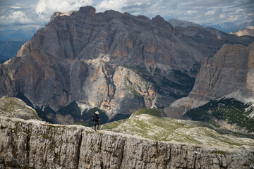 Hiker enjoys the view from Lagazuoi mountain over the italian Dolomites.