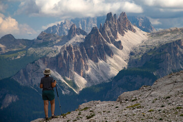Naklejka premium Mountain view with woman climber and Croda di Lago mountain, Dolomites, Italy.