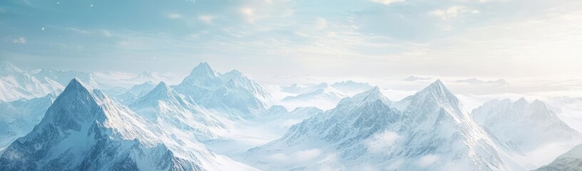 Fototapeta premium Majestic mountain landscape with snow-covered peaks and soft clouds, evoking a sense of tranquility and nature's grandeur.