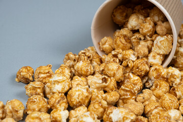 Sweet caramelized popcorn spilled out of the glass.
