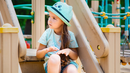 Kid on playground. little girl play outdoor on school yard slide. Healthy activity. Child playing in sunny park. Kid having fun on colorful slide.