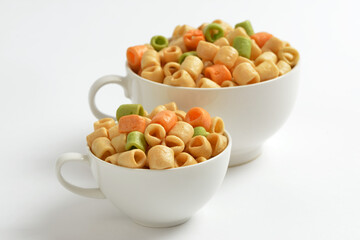 Colorful macaroni puffed rice on cups with white background, South Korea