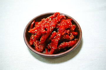 Korean food(Deodeogmuchim) in a bowl with cloth background, South Korea