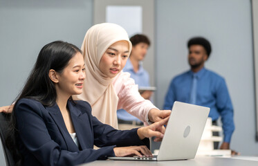 Muslim businesswoman in hijab presenting data charts and world map in a meeting, business presentation, professional teamwork, analysis, data-driven strategy, diverse workplace, business communication