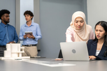 Muslim businesswoman in hijab presenting data charts and world map in a meeting, business presentation, professional teamwork, analysis, data-driven strategy, diverse workplace, business communication