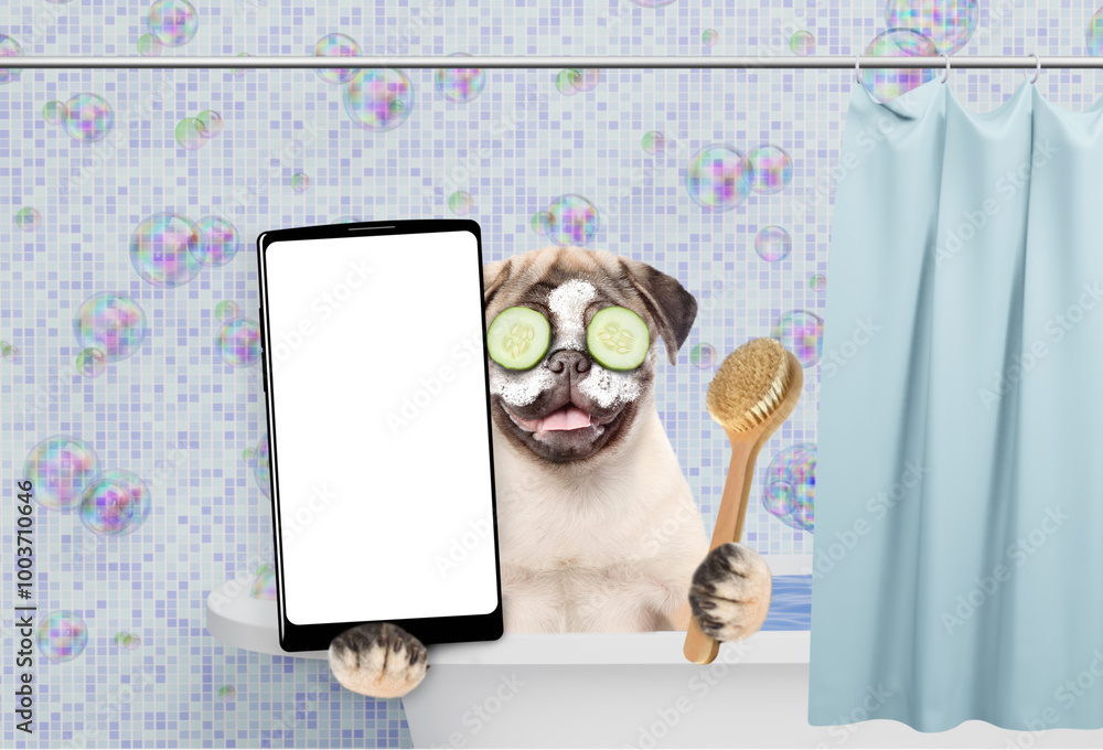 Aufkleber Happy Pug puppy with cream on it face and with slices of cucumber in it eyes takes the bath and shows big smartphone with white blank screen in it paw. Empty space for text