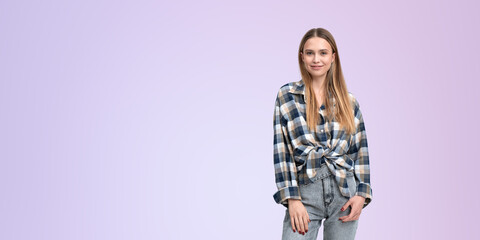 Young woman in denim jeans and shirt, empty colored background