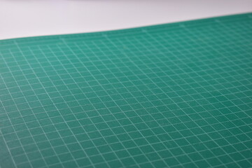 green cutting mat board on white background with line and scale measure guide pattern for object...