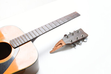 part of broken wood acoustic guitar isolated on white background