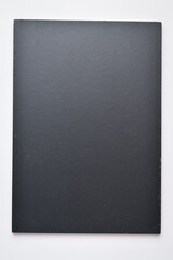 blank black notebook on white background