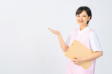案内するエプロンをつけた女性　保育士　介護福祉士