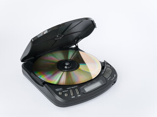 Close-up view of CD player with open lid and golden CD inside isolated on white background