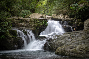 River goes like stair from the beautiful shape rocks, hidden in the forest, in Manyueyuan Forest Recreation Area, New Taipei City, Taiwan.