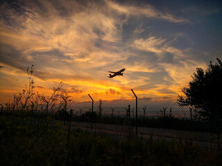 Avión despegando en medio de un atardecer.