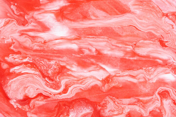 Abstract background mixing red and white paints.
