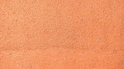 Fototapeta premium Abstract orange color cement wall background texture. Orange color dirty texture closeup