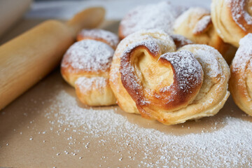 Buns in the shape of a heart sprinkled with powdered sugar.