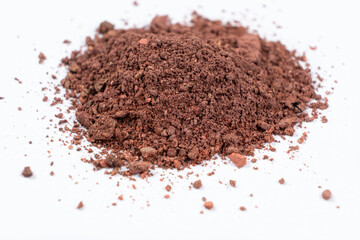 A mixture of different shades of eyeshadow on a white background.