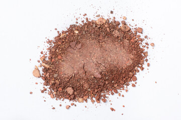 A mixture of different shades of eyeshadow on a white background.