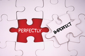 Fototapeta premium Motivational and inspirational words. PERFECTLY IMPERFECT written on jigsaw puzzle pieces.
