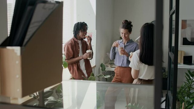 Employees having lunch break at modern office
