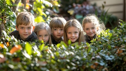 Five children peeking through foliage, showcasing playful curiosity and nature.