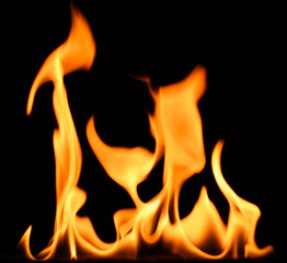 fire on a black background, burning and hot flames, close view