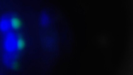 Blue bokeh light effect against a dark background. The speed of light creates beautiful compositions.