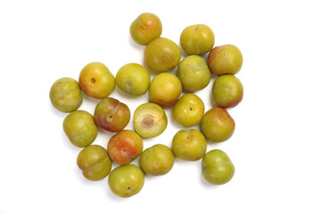 Ripe sweet small mini plum green maroon on white background