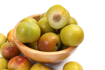 Ripe sweet small mini plum green maroon on white background
